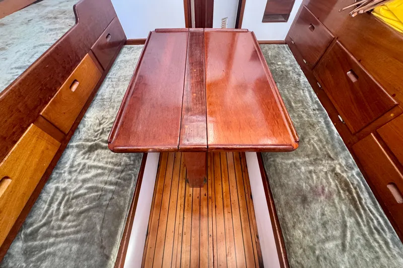 Slide: The Image of Interior of a 1946 Phillip Rhodes 42 sailboat with wooden table and storage drawers. - 24