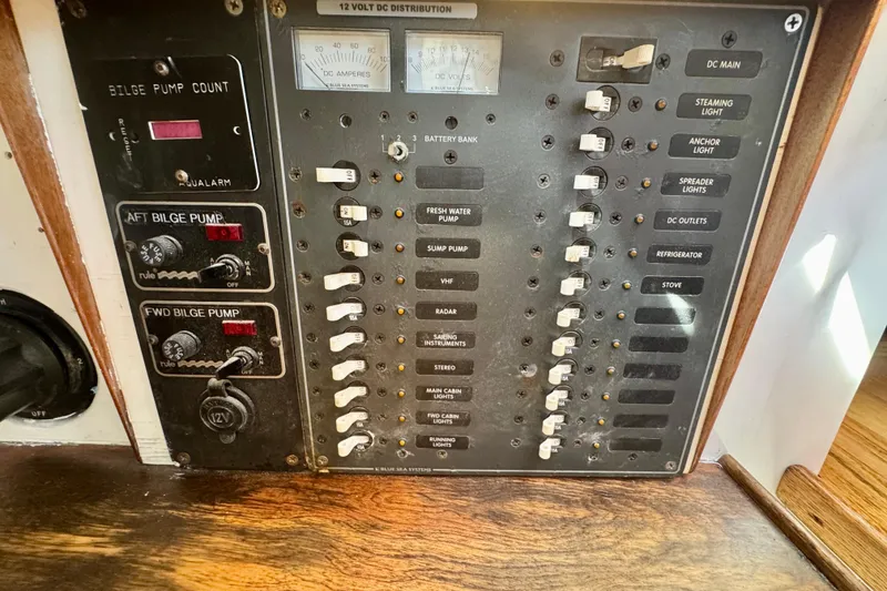 Slide: The Image of Electrical control panel on a 1946 Phillip Rhodes 42 boat, featuring switches and gauges. - 25