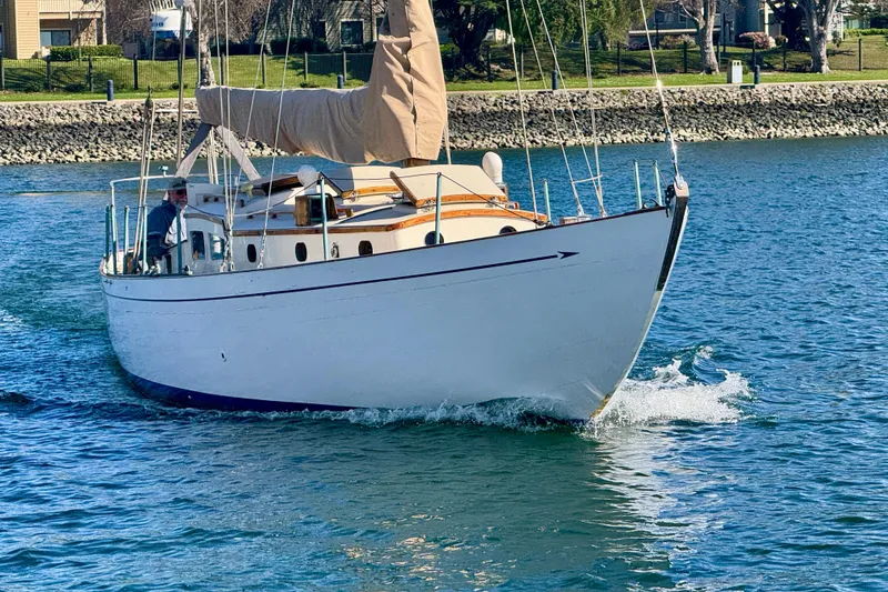 Slide: The Image of Vintage 1946 Phillip Rhodes 42 sailboat cruising on a sunny day in calm waters. - 3