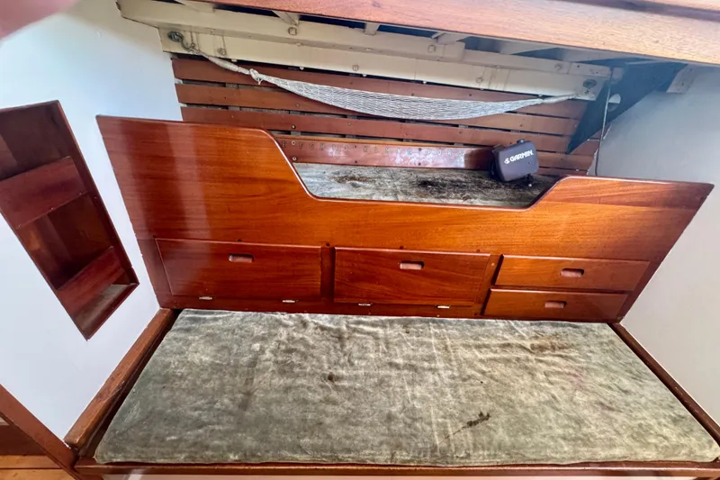 Slide: The Image of Wooden interior of a 1946 Phillip Rhodes 42 boat with storage drawers and a cushioned bench. - 34