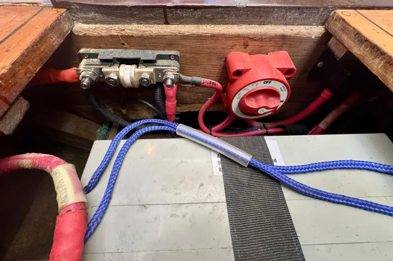 Slide: The Image of Electrical system with red switch and cables in a 1946 Phillip Rhodes 42 model boat. - 38