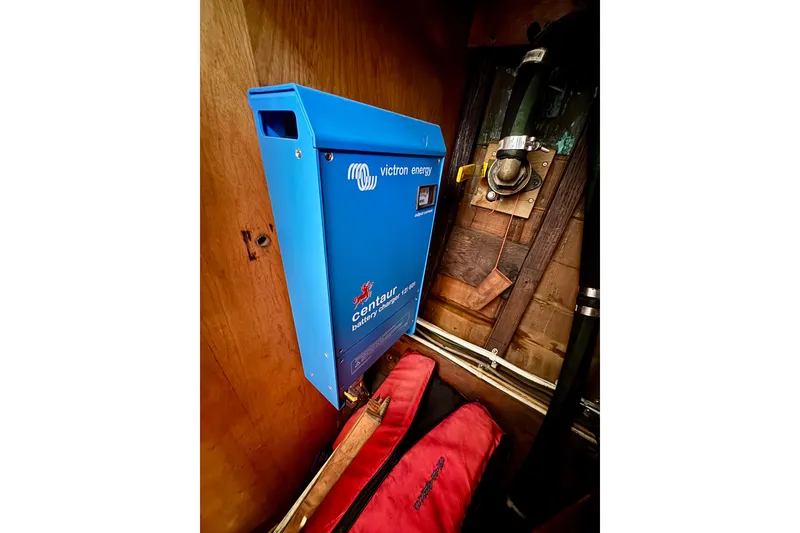 Slide: The Image of Blue Victron Energy Centaur battery charger installed on a wooden wall, Phillip Rhodes 42, 1946. - 40