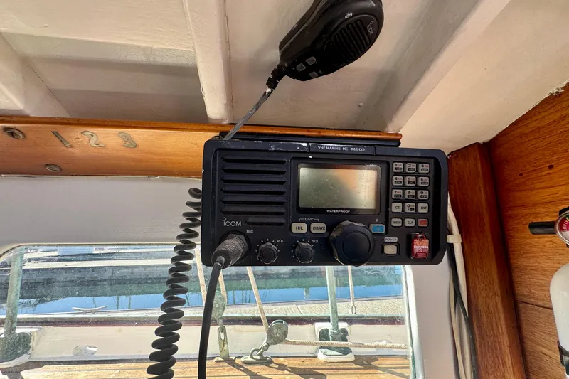 Slide: The Image of VHF marine radio on a 1946 Phillip Rhodes 42 boat, mounted under a wooden panel. - 42