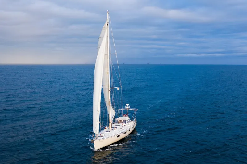 The Image of Sundeer 56 sailboat from 1995 navigating open ocean under cloudy skies. - 0