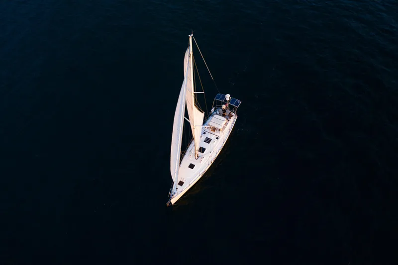Slide: The Image of Aerial view of 1995 Sundeer 56 sailboat navigating calm waters. - 13