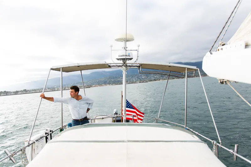 Slide: The Image of Man on 1995 Sundeer 56 yacht, ocean view, American flag, overcast sky. - 17
