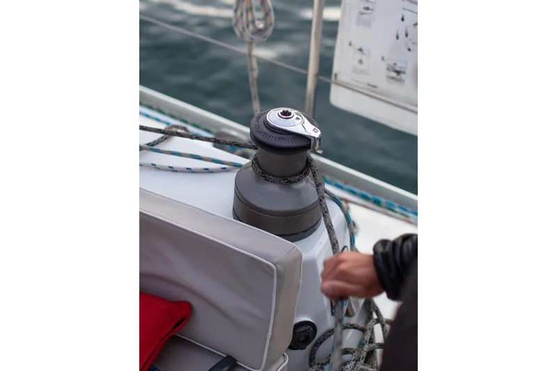 Slide: The Image of Sailing winch on a 1995 Sundeer 56 yacht, with ropes and hand visible. - 18