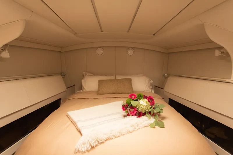 Slide: The Image of Luxurious cabin interior of 1995 Sundeer 56 yacht with cozy bed and flowers. - 20