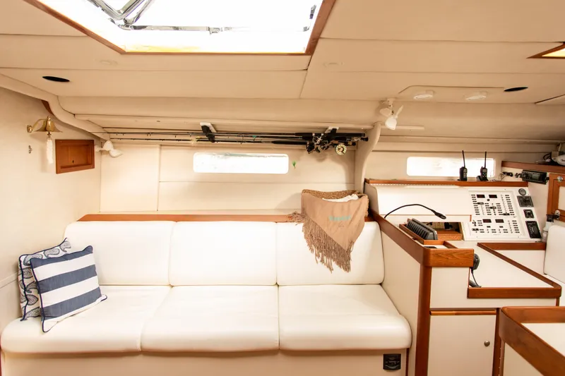 Slide: The Image of Interior of a 1995 Sundeer 56 yacht with white seating and navigation equipment. - 27