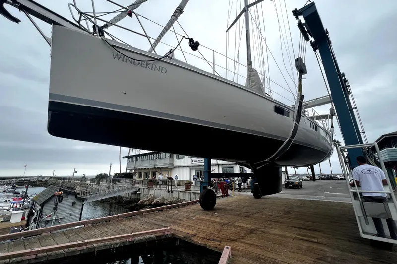 Slide: The Image of Sundeer 56 sailboat from 1995 being lifted at a marina dock. - 29