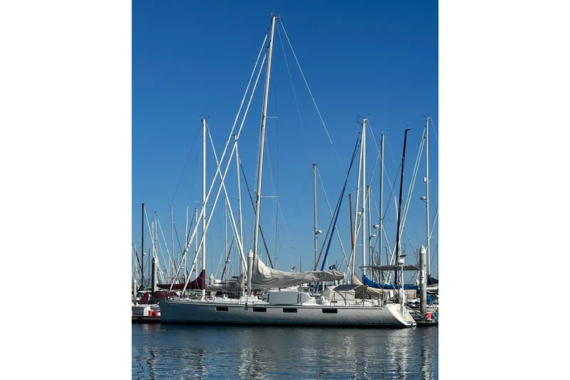 Slide: The Image of Sundeer 56 sailboat from 1995 docked in a marina under clear blue skies. - 3