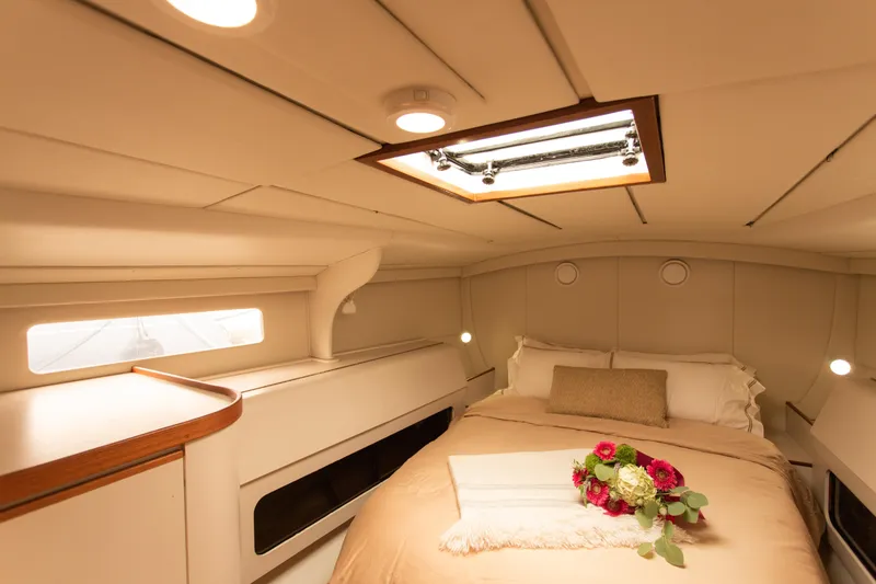Slide: The Image of Luxurious cabin interior of a 1995 Sundeer 56 yacht with cozy bedding and floral decor. - 38