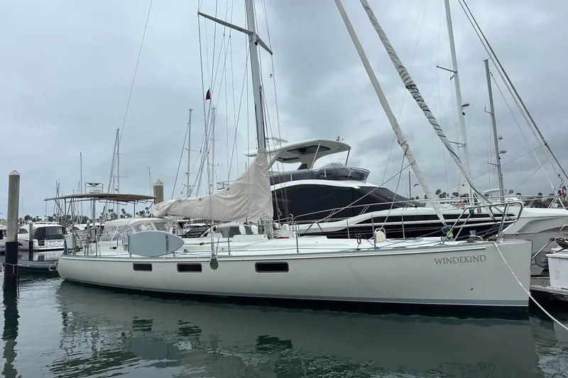 Slide: The Image of Sundeer 56 sailboat from 1995 docked in a marina, overcast sky. - 4