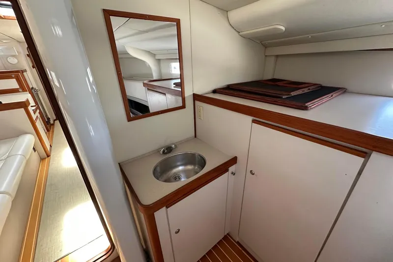 Slide: The Image of Interior of 1995 Sundeer 56 yacht with sink, mirror, and wooden cabinetry. - 40