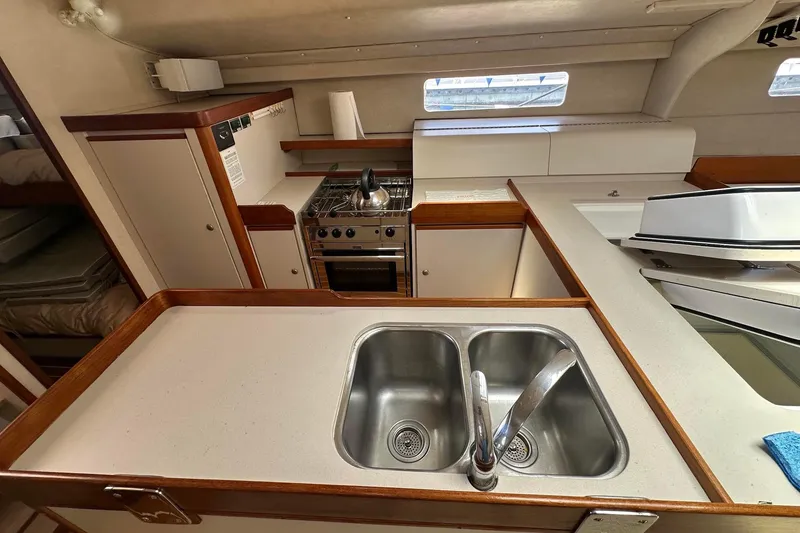 Slide: The Image of Interior of a 1995 Sundeer 56 yacht kitchen with sink and stove. - 45