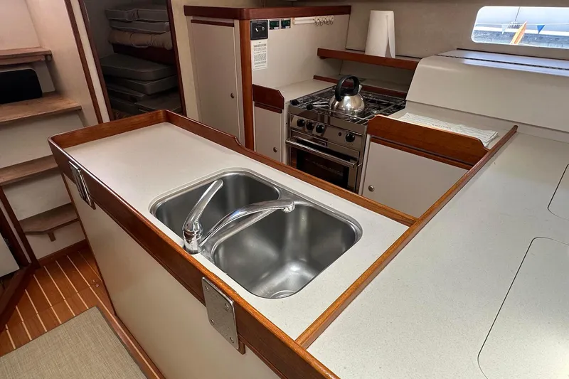 Slide: The Image of Modern kitchen area in a 1995 Sundeer 56 yacht with sink and stove. - 47