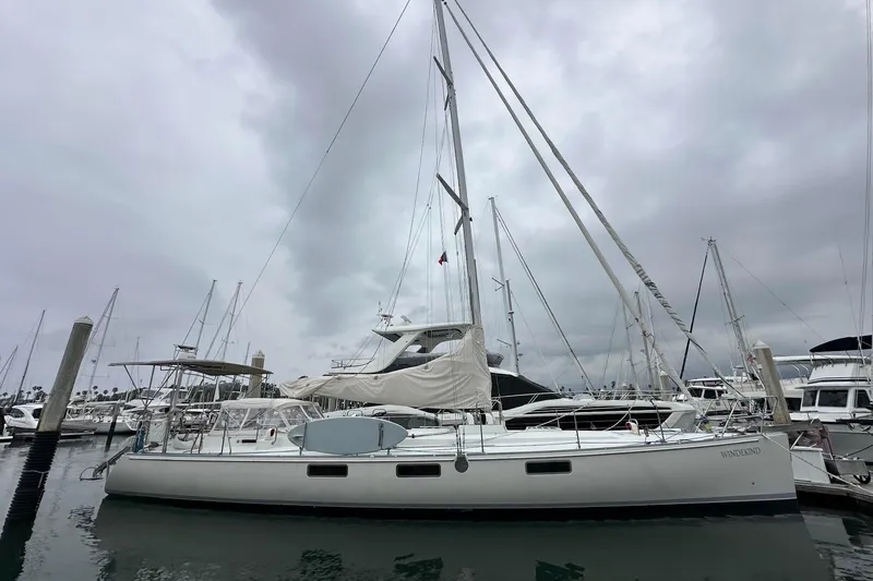 Slide: The Image of Sundeer 56 sailboat from 1995 docked in a marina under cloudy skies. - 5