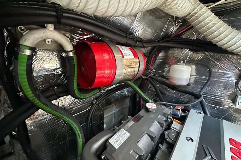 Slide: The Image of Engine room of a 1995 Sundeer 56 yacht with fire extinguisher and hoses. - 53