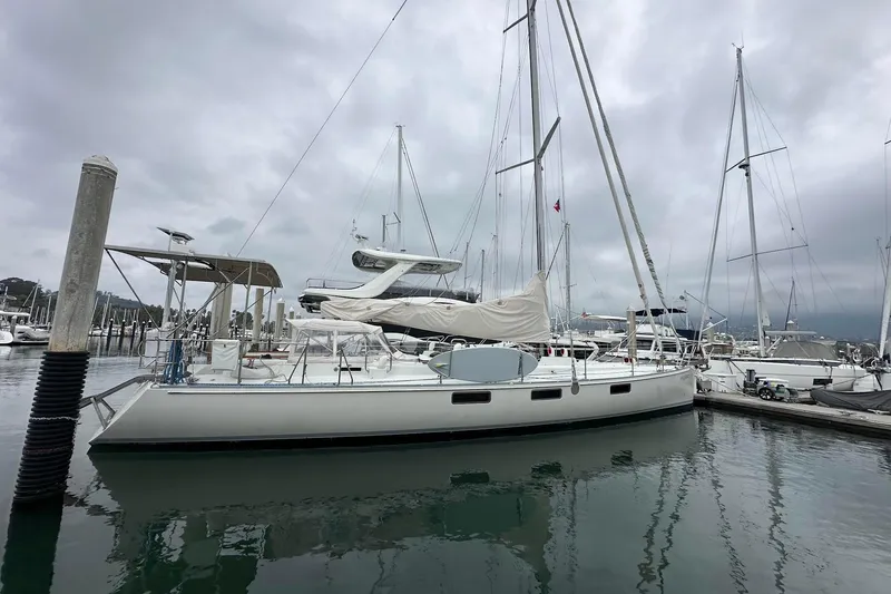 Slide: The Image of Sundeer 56 sailboat from 1995 docked in a marina under cloudy skies. - 6