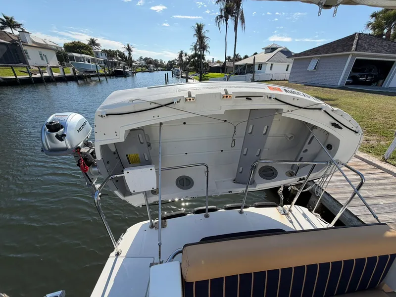 Slide: The Image of 2013 Ranger Tugs R-31 CB boat by the water with outboard motor. - 11