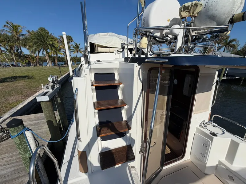 Slide: The Image of 2013 Ranger Tugs R-31 CB with wooden steps and deck view. - 15