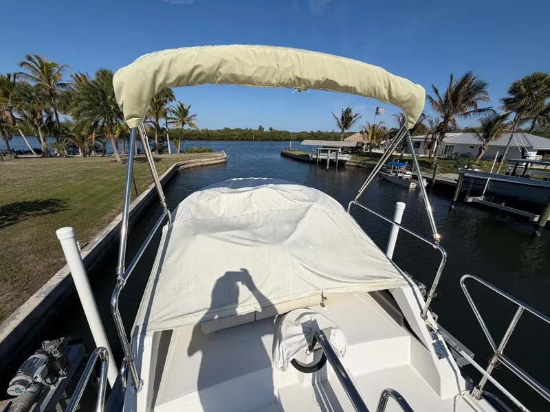 Slide: The Image of 2013 Ranger Tugs R-31 CB on water with palm trees in background. - 16