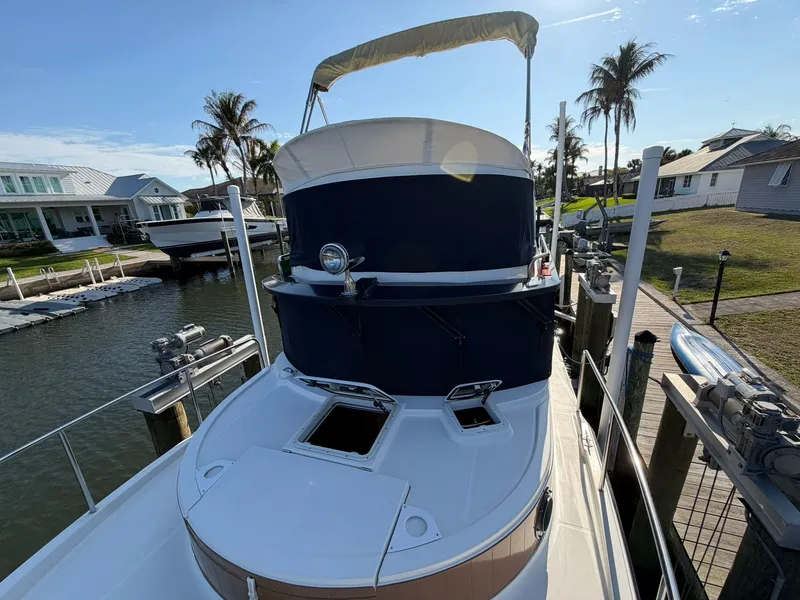 Slide: The Image of 2013 Ranger Tugs R-31 CB boat docked with palm trees in the background. - 22