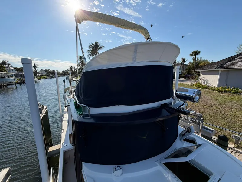 Slide: The Image of 2013 Ranger Tugs R-31 CB boat docked under sunny skies. - 23