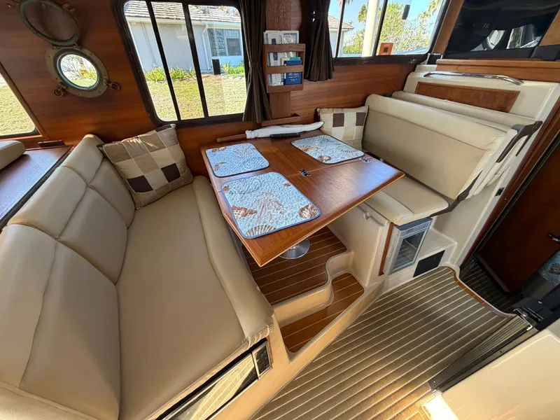 Slide: The Image of Interior of 2013 Ranger Tugs R-31 CB with cozy seating area. - 36