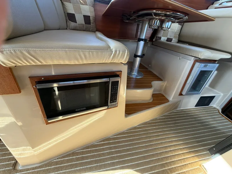 Slide: The Image of Interior of 2013 Ranger Tugs R-31 CB with microwave and seating area. - 37