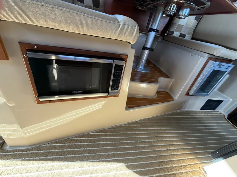 Slide: The Image of Interior of 2013 Ranger Tugs R-31 CB with microwave and carpeted floor. - 39