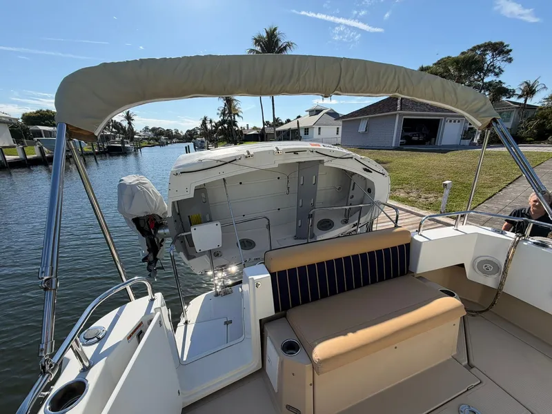 Slide: The Image of 2013 Ranger Tugs R-31 CB on water, featuring seating area and sunshade. - 5