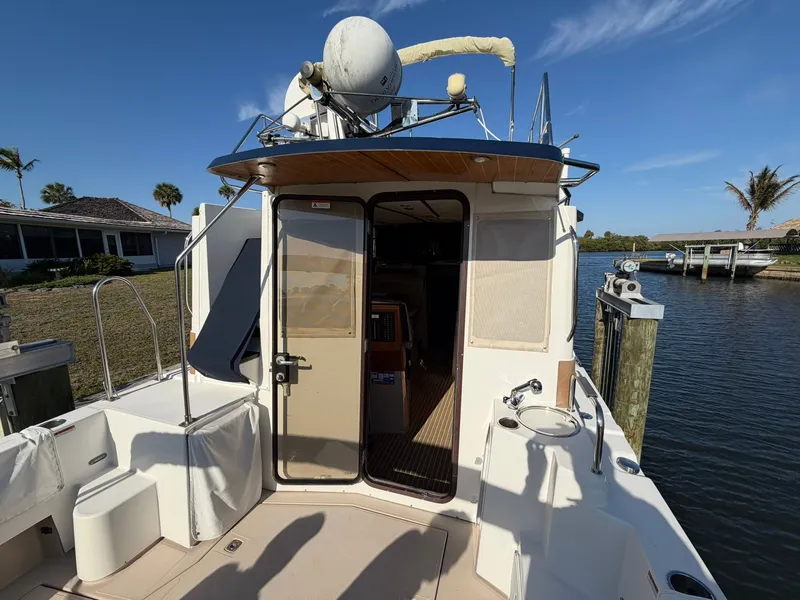 Slide: The Image of 2013 Ranger Tugs R-31 CB at dock with open entrance. - 8