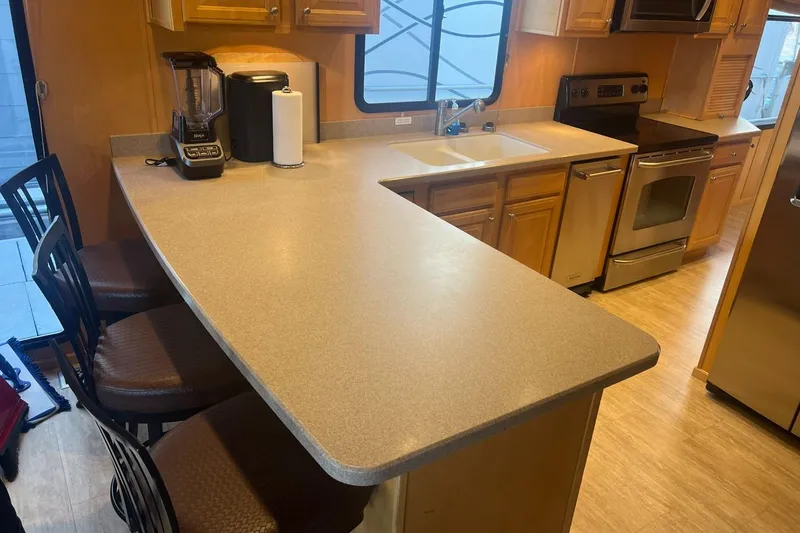 Slide: The Image of Modern kitchen interior with wooden cabinets, stainless steel appliances, and a spacious countertop. - 10