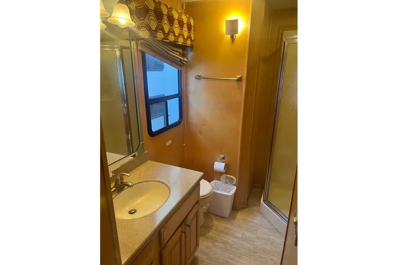 Slide: The Image of Bathroom interior of 2007 American Waterways Sundancer Trip #3, featuring sink, toilet, and shower. - 14