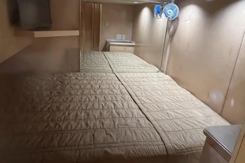 Slide: The Image of Interior cabin of 2007 American Waterways Sundancer, featuring a cozy bed and small fan. - 18