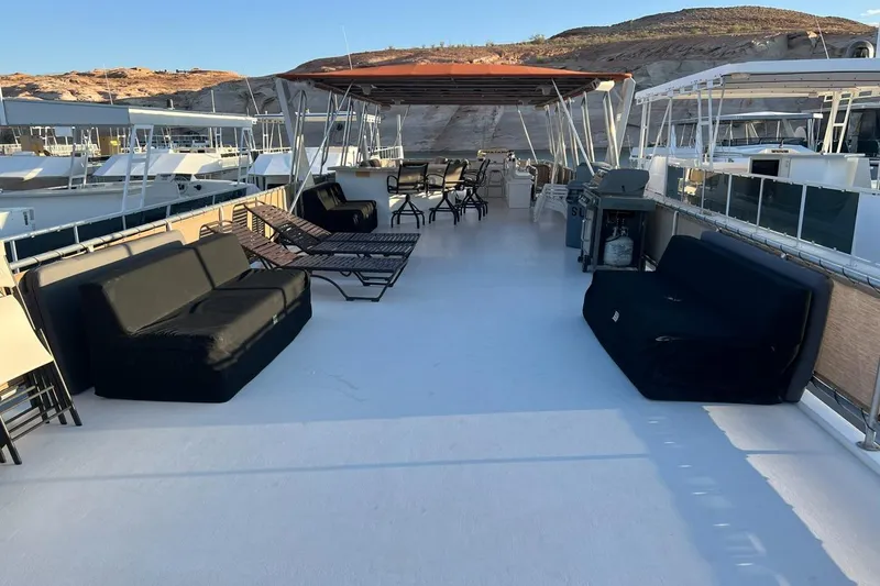 Slide: The Image of Spacious deck of 2007 American Waterways Sundancer, featuring lounge chairs and shaded seating. - 22