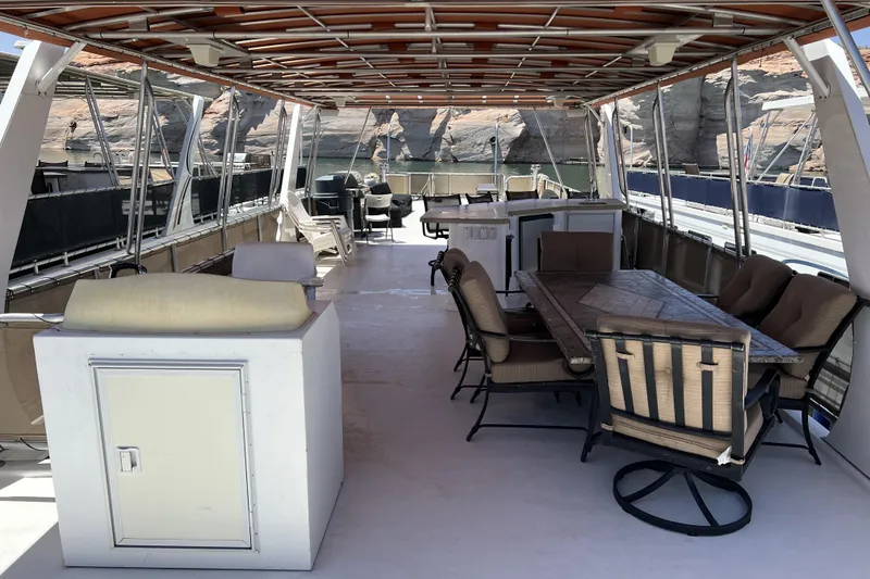 Slide: The Image of Spacious deck of 2007 American Waterways Sundancer, featuring seating and dining area. - 23
