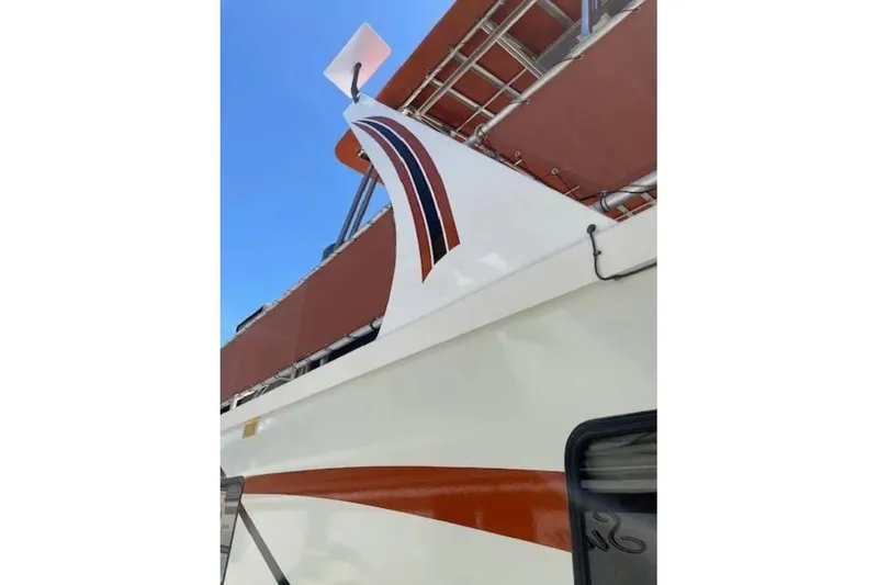 Slide: The Image of Close-up of 2007 American Waterways Sundancer boat with red and white design. - 4