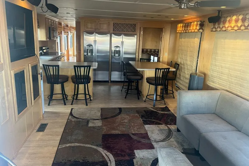 Slide: The Image of Luxurious houseboat interior with modern kitchen, bar stools, and cozy seating area, 2007 Sundancer Trip. - 6