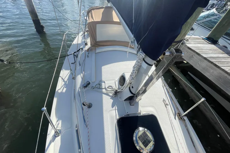 Slide: The Image of 2013 Hake Seaward 26RK sailboat docked, showcasing deck and rigging details. - 11