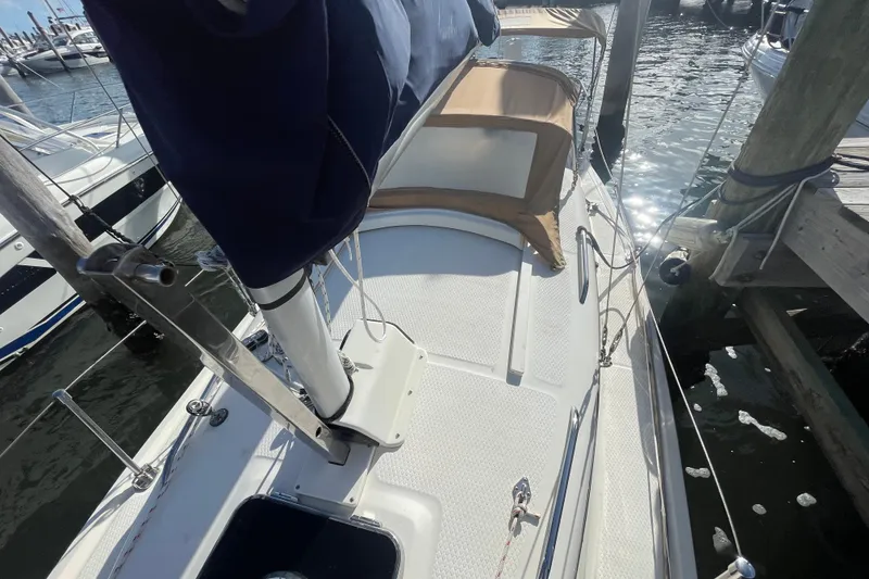 Slide: The Image of 2013 Hake Seaward 26RK sailboat docked, featuring deck and mast details. - 12