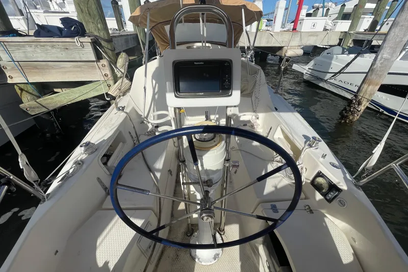 Slide: The Image of Cockpit of 2013 Hake Seaward 26RK sailboat with steering wheel and navigation equipment. - 13