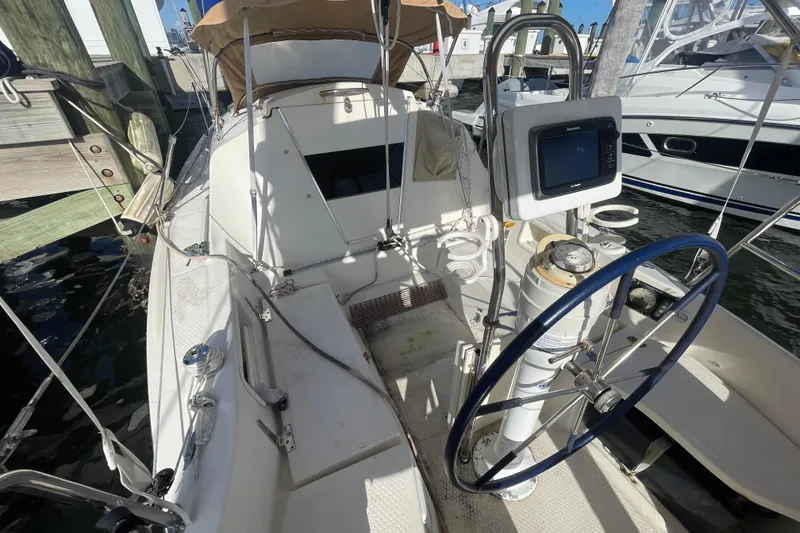 Slide: The Image of Cockpit of 2013 Hake Seaward 26RK sailboat with steering wheel and navigation equipment. - 24