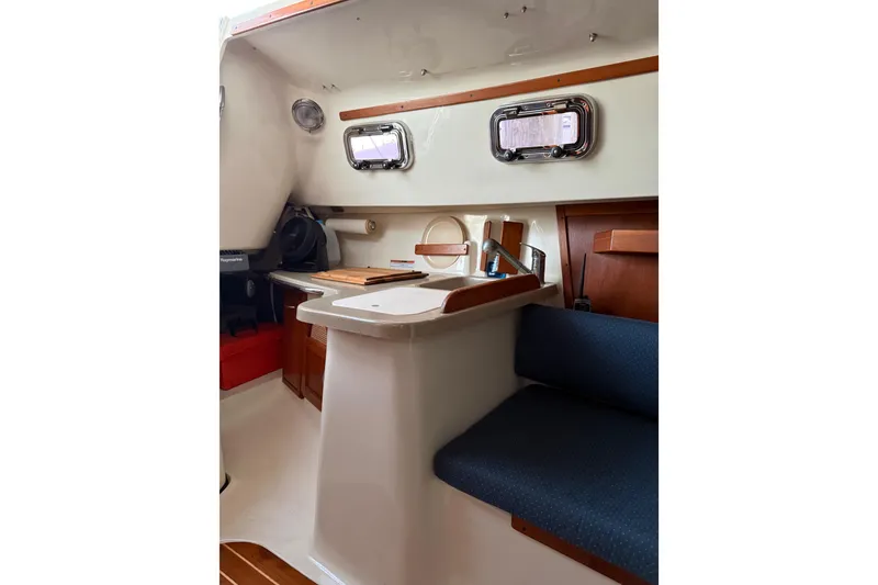 Slide: The Image of Interior of 2013 Hake Seaward 26RK sailboat with compact kitchen and seating area. - 29