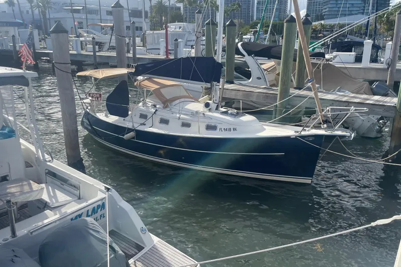 Slide: The Image of 2013 Hake Seaward 26RK sailboat docked, for sale sign visible. - 3