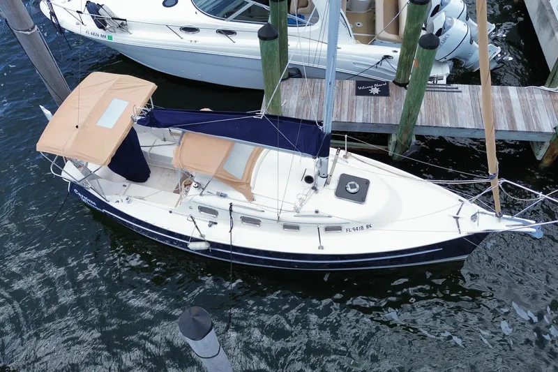 Slide: The Image of 2013 Hake Seaward 26RK sailboat docked, featuring tan canopy and sleek design. - 34