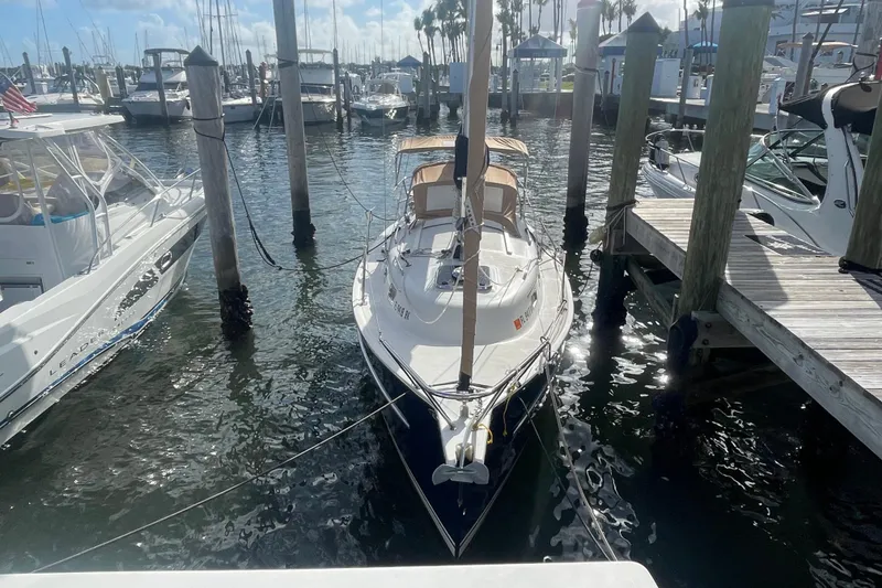 Slide: The Image of 2013 Hake Seaward 26RK sailboat docked at marina with surrounding boats. - 5