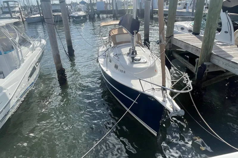 Slide: The Image of 2013 Hake Seaward 26RK sailboat docked at marina, surrounded by water and other boats. - 6