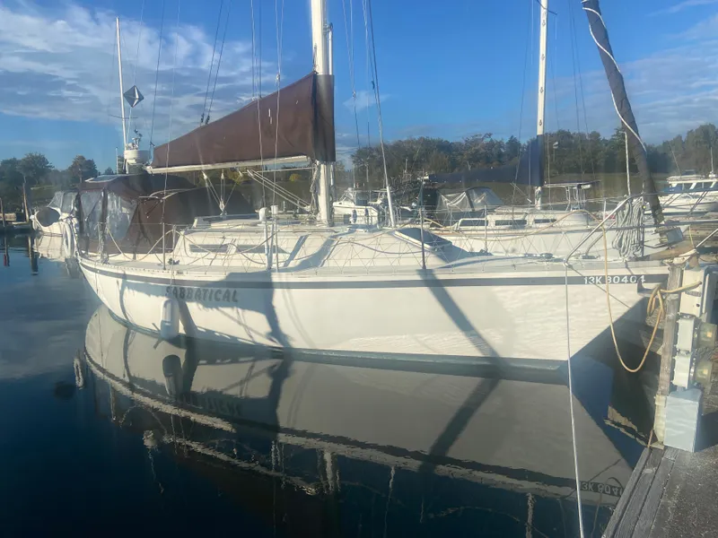 Slide: The Image of 1981 CS 33 sailboat docked in harbor on a sunny day. - 1